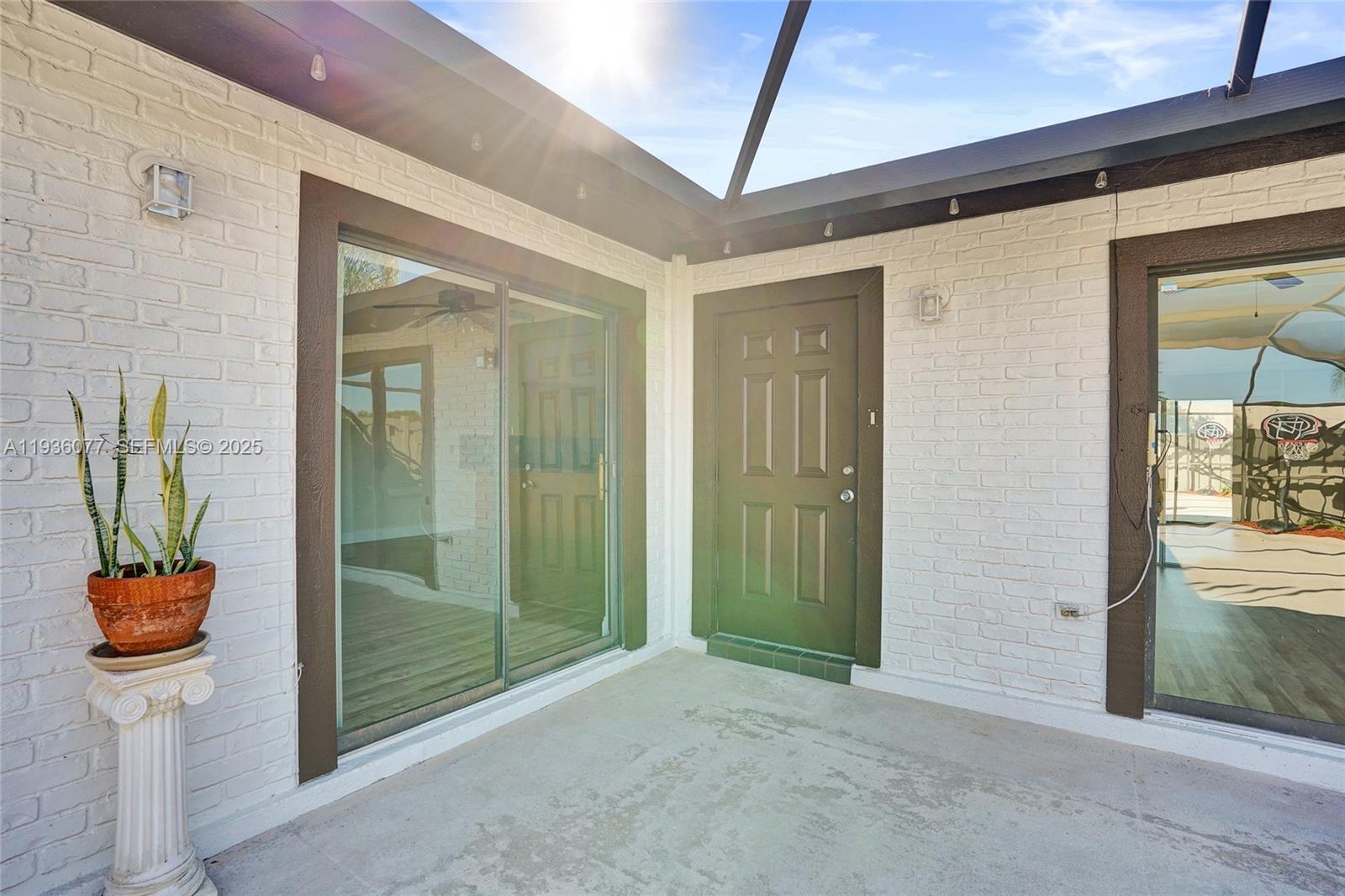 9569 Boca Gardens Parkway, Unit B Boca Raton, FL 33496 - Photo 9 of 40 a view of a hallway with wooden floor and a bathroom