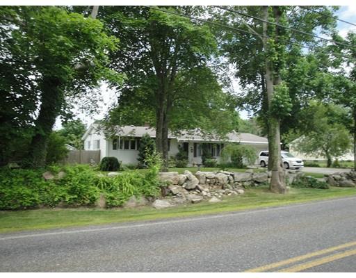 104 Forge Road Westport, MA 02790 - Photo 2 of 17 a front view of a house with a garden and trees