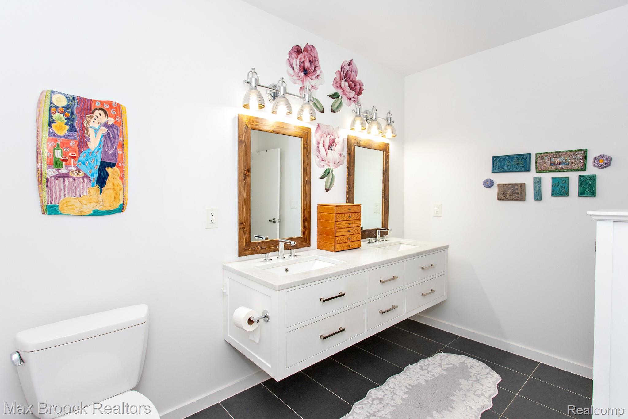 211 East 9 Mile Road, Unit 307 Ferndale, MI 48220 - Photo 37 of 60 Bathroom with double vanity and dark tile patterned flooring