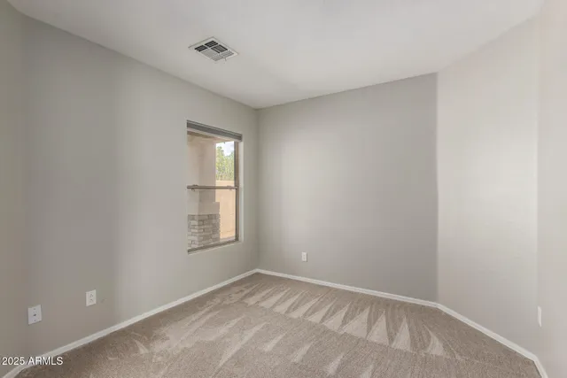 an empty room with fan and entrance