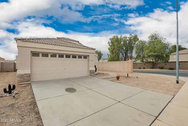 a view of a kitchen with a dishwasher a kitchen island hardwood floor and a sink