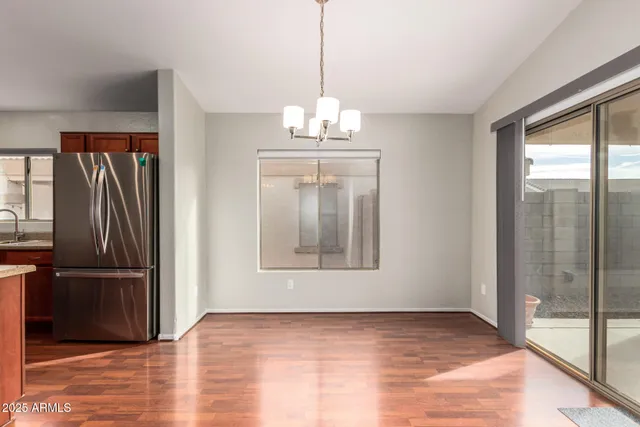 a kitchen with stainless steel appliances granite countertop a sink stove microwave and refrigerator