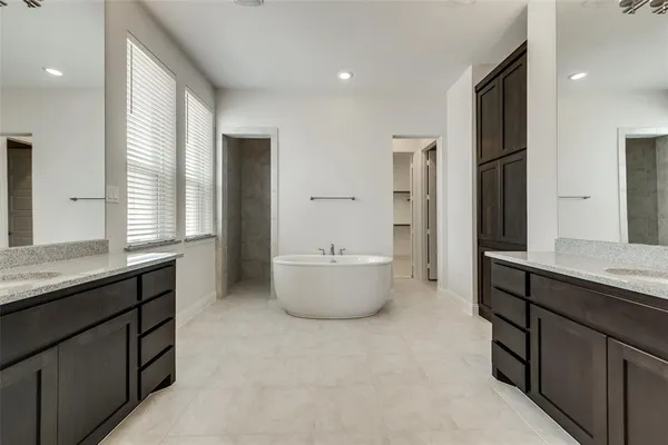 a bathroom with a granite countertop sink a toilet and mirror