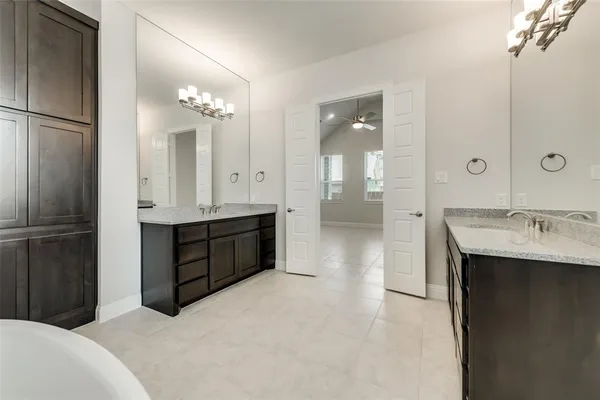 a bathroom with a double vanity sink a mirror and a shower