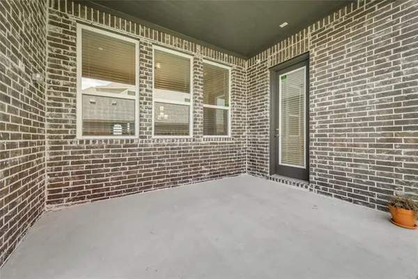 a view of a brick house with many windows