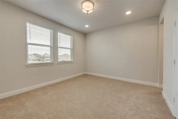 an empty room with windows and closet