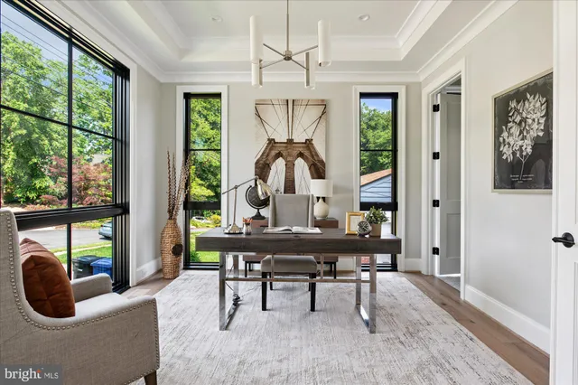 a view of a dining room with furniture a chandelier and wooden floor