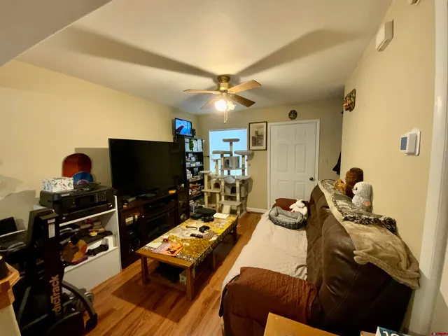 a bedroom with furniture and a flat screen tv
