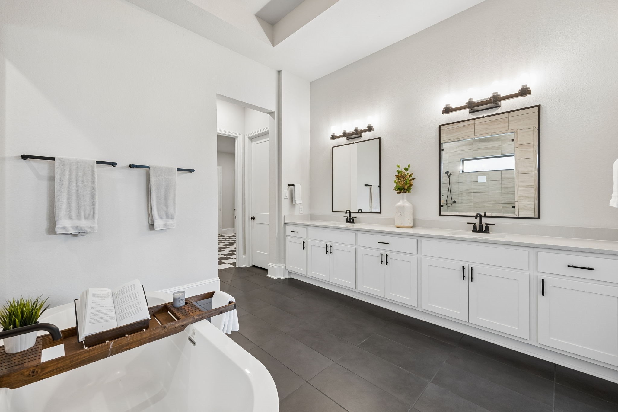 10102 South Goshawk Trail Conroe, TX 77385 - Photo 36 of 46 a spacious bathroom with double vanity sinks a mirror a vanity and a shower