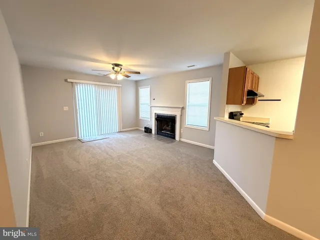 a view of a kitchen with a sink and a fireplace
