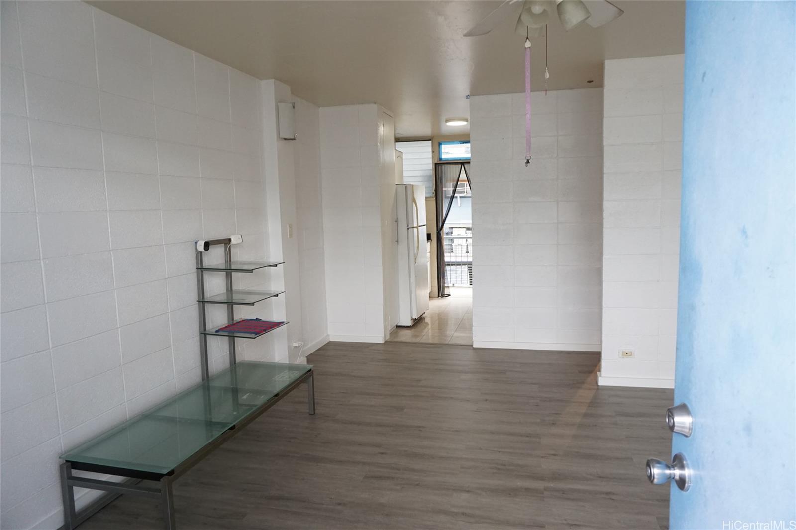 1209 Kokea Street, Unit F203 Honolulu, HI 96817 - Photo 11 of 14 a view of empty room with wooden floor