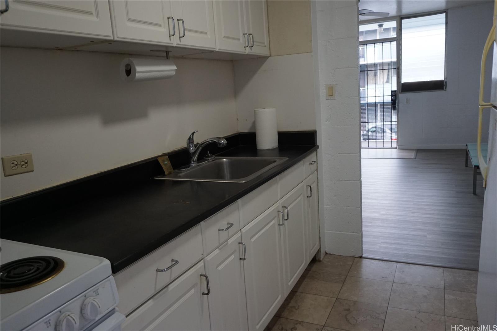 1209 Kokea Street, Unit F203 Honolulu, HI 96817 - Photo 5 of 14 a kitchen with a sink and cabinets