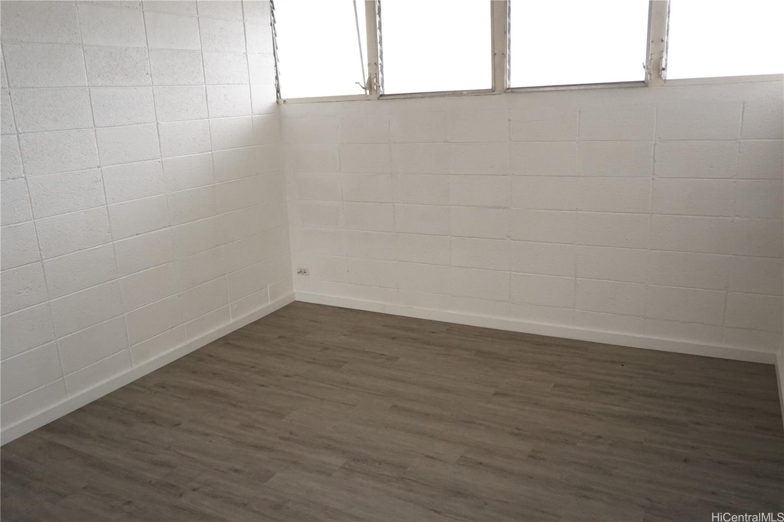 1209 Kokea Street, Unit F203 Honolulu, HI 96817 - Photo 9 of 14 a view of a small space with wooden floor and a window