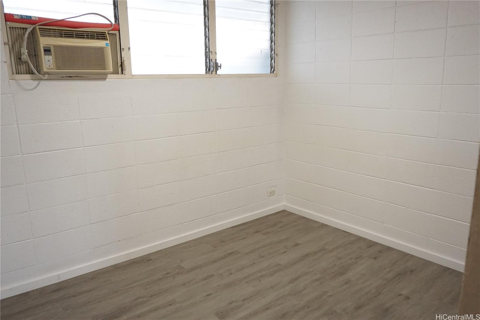 1209 Kokea Street, Unit F203 Honolulu, HI 96817 - Photo 10 of 14 a view of a small space with wooden floor and a window