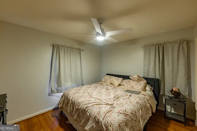 a bed sitting in a bedroom next to a window