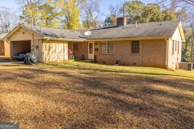 a view of a house with a patio and a yard