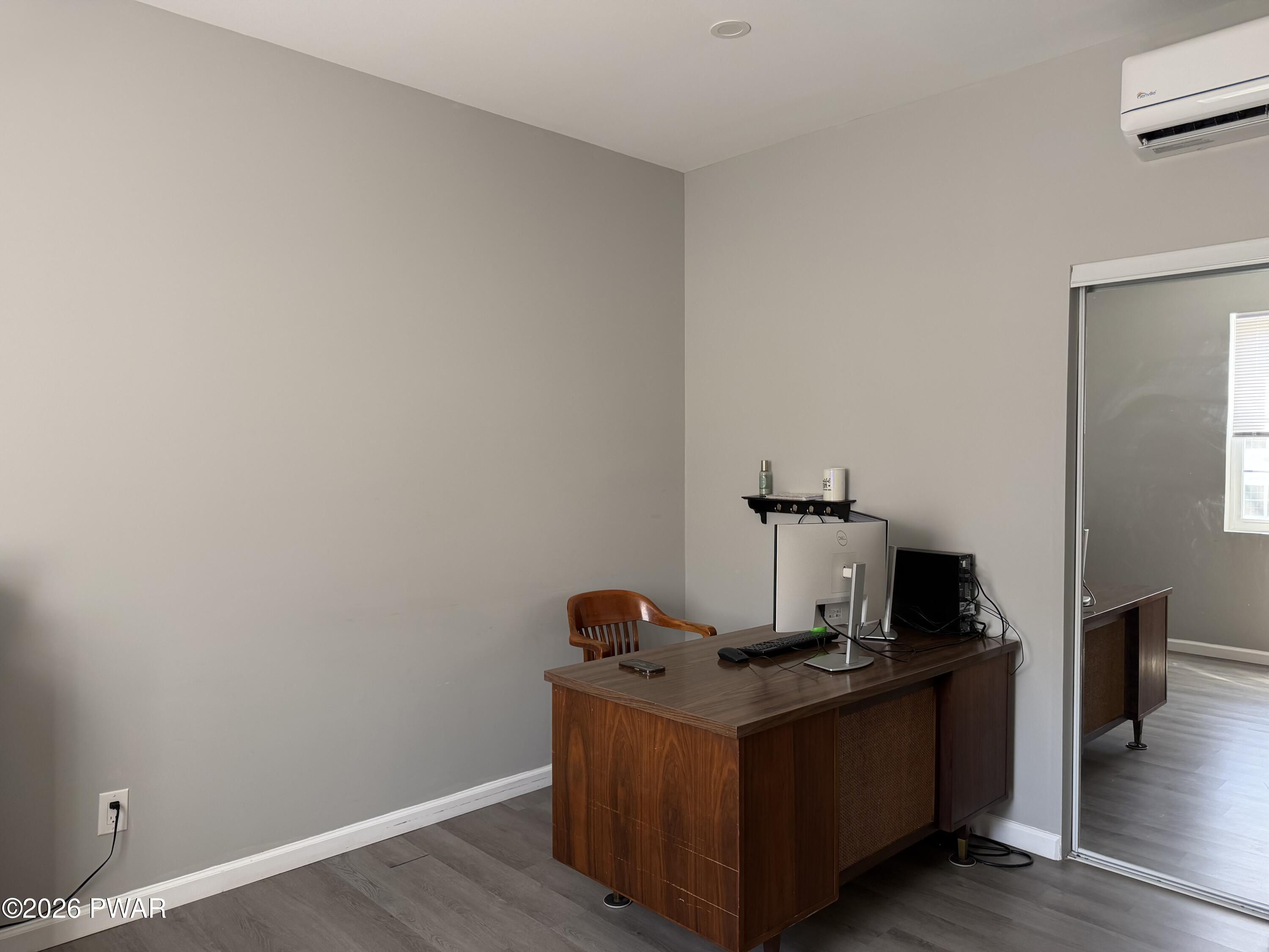 801 Maple Ridge Court Hawley, PA 18428 - Photo 28 of 55 a room with wooden floor and black wall
