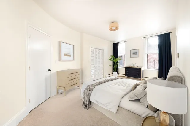 a bedroom with a bed and a couch