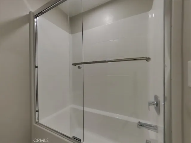 an empty room with a space and windows