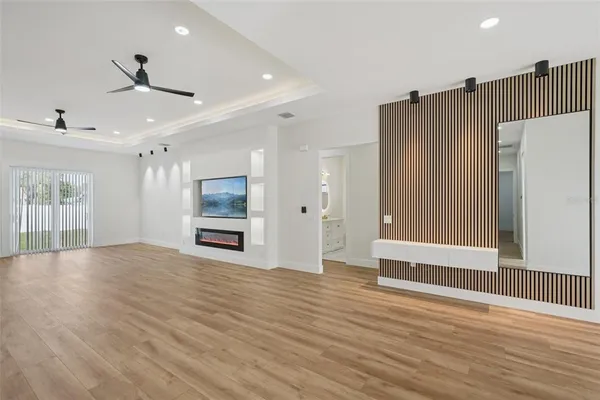 a kitchen with stainless steel appliances granite countertop a sink a stove and a wooden floors