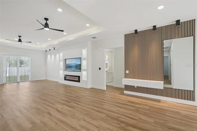 a kitchen with stainless steel appliances granite countertop a sink a stove and a wooden floors