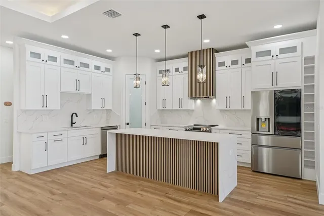 a view of a small space with wooden floor and a sink