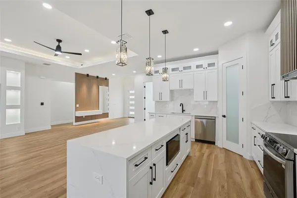 a bathroom with a double vanity sink toilet and shower