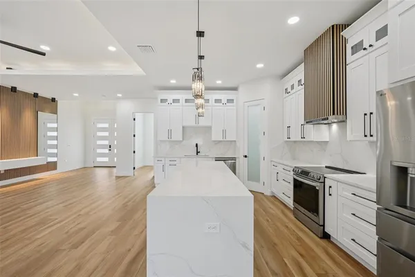 a bathroom with a granite countertop sink mirror bathtub and toilet