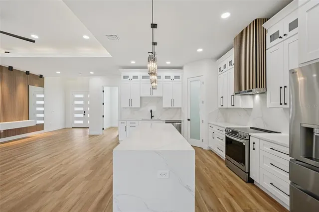 a bathroom with a granite countertop sink mirror bathtub and toilet