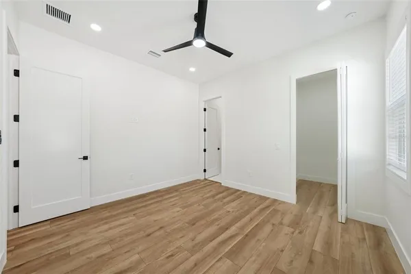 an aerial view of residential houses with outdoor space and trees