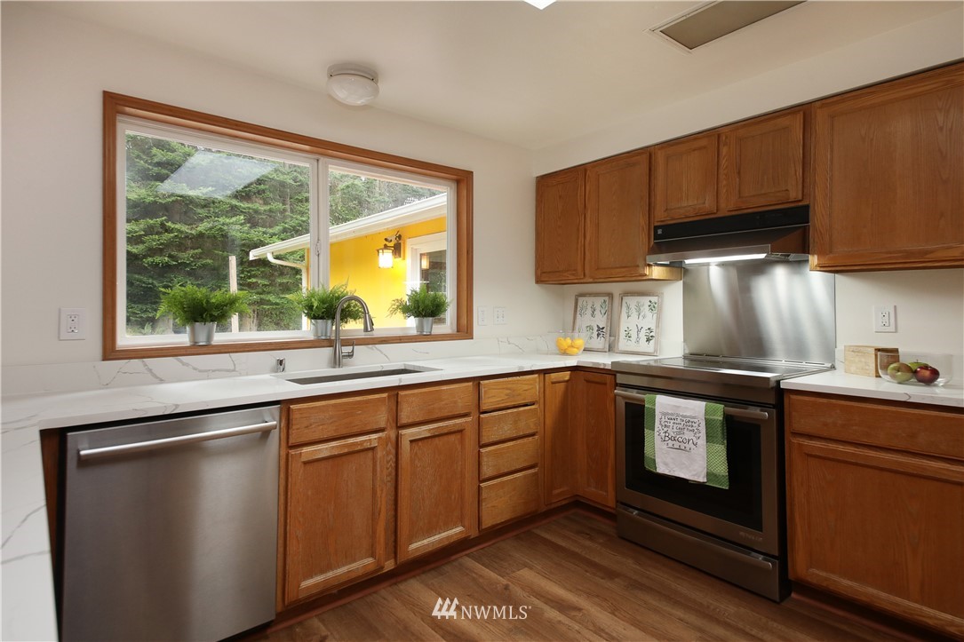6416 Wahl Road Freeland, WA 98249 - Photo 16 of 40 a kitchen with a sink stove and cabinets