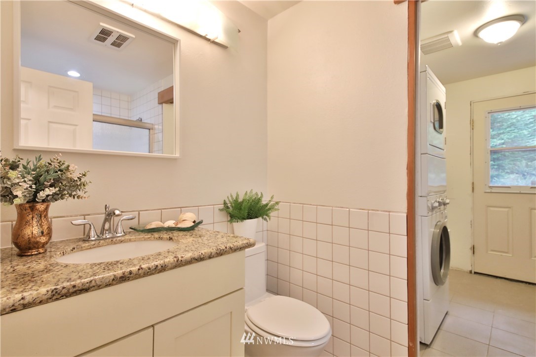 6416 Wahl Road Freeland, WA 98249 - Photo 26 of 40 a bathroom with a granite countertop sink toilet and shower
