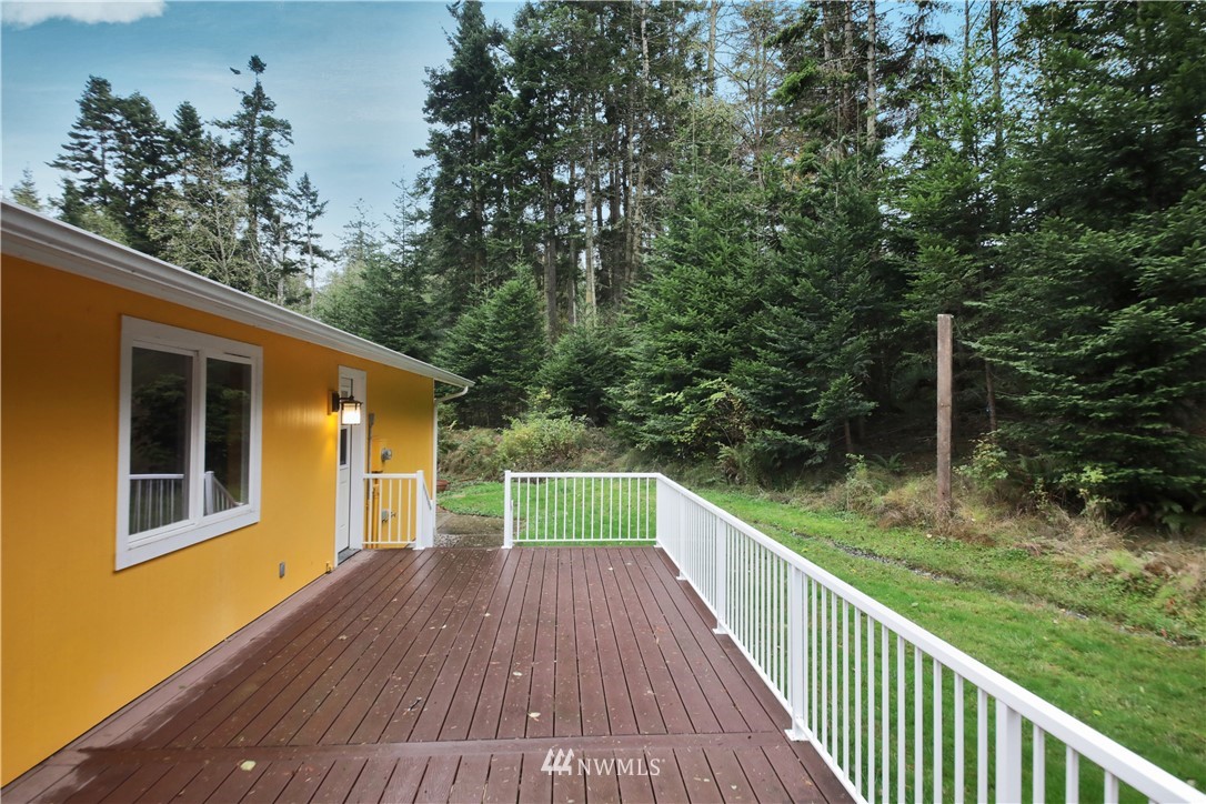 6416 Wahl Road Freeland, WA 98249 - Photo 30 of 40 a balcony with wooden floor and trees in the back