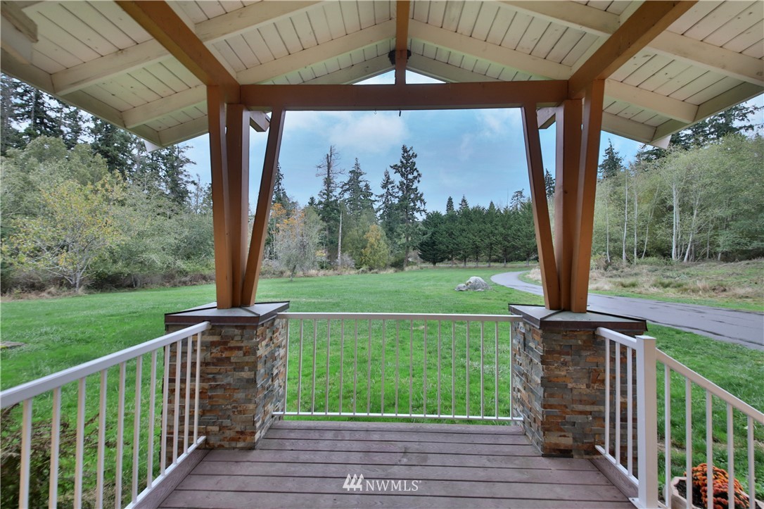 6416 Wahl Road Freeland, WA 98249 - Photo 4 of 40 a view of a deck with a big yard potted plants and large tree