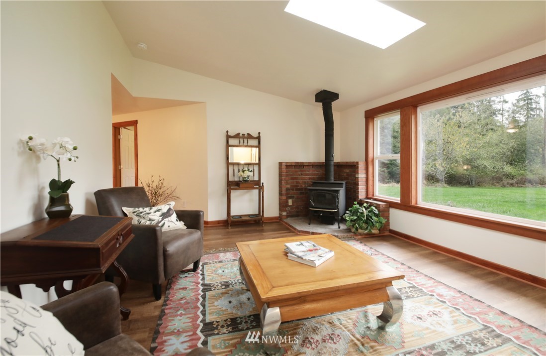 6416 Wahl Road Freeland, WA 98249 - Photo 5 of 40 a living room with furniture and a fireplace