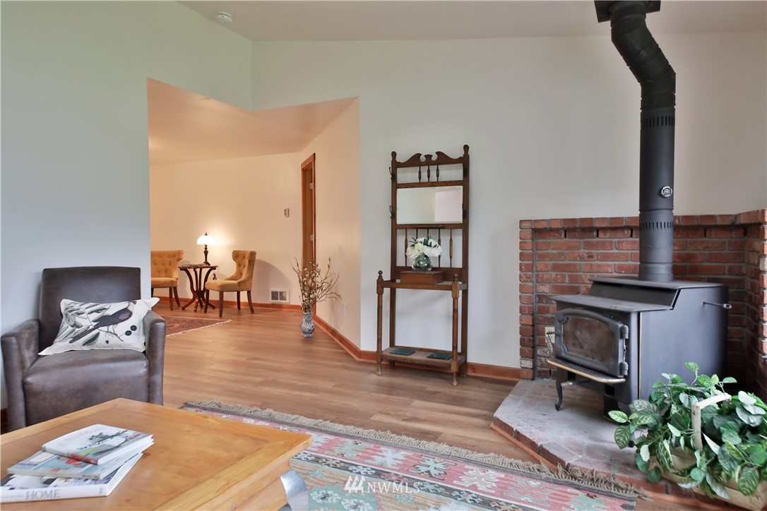 6416 Wahl Road Freeland, WA 98249 - Photo 7 of 40 a living room with furniture and a fireplace