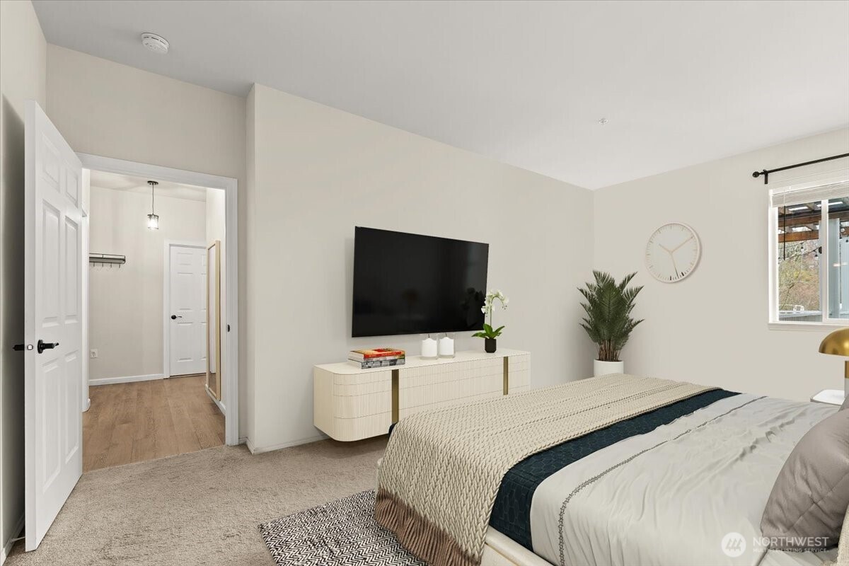 17426 Bothell Way Northeast, Unit A302 Bothell, WA 98011 - Photo 21 of 40 a bedroom with a bed and a flat screen tv