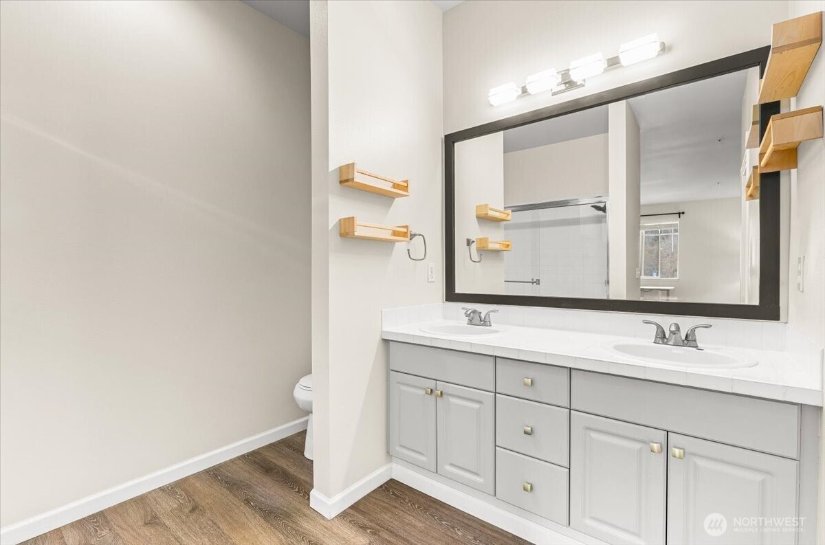 17426 Bothell Way Northeast, Unit A302 Bothell, WA 98011 - Photo 23 of 40 a bathroom with a double vanity sink and a mirror