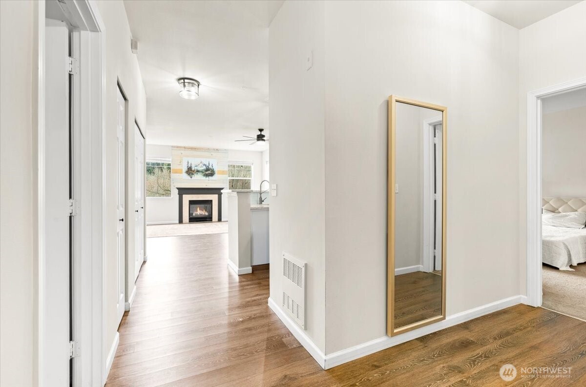 17426 Bothell Way Northeast, Unit A302 Bothell, WA 98011 - Photo 32 of 40 a view of a hallway with wooden floor and a living room