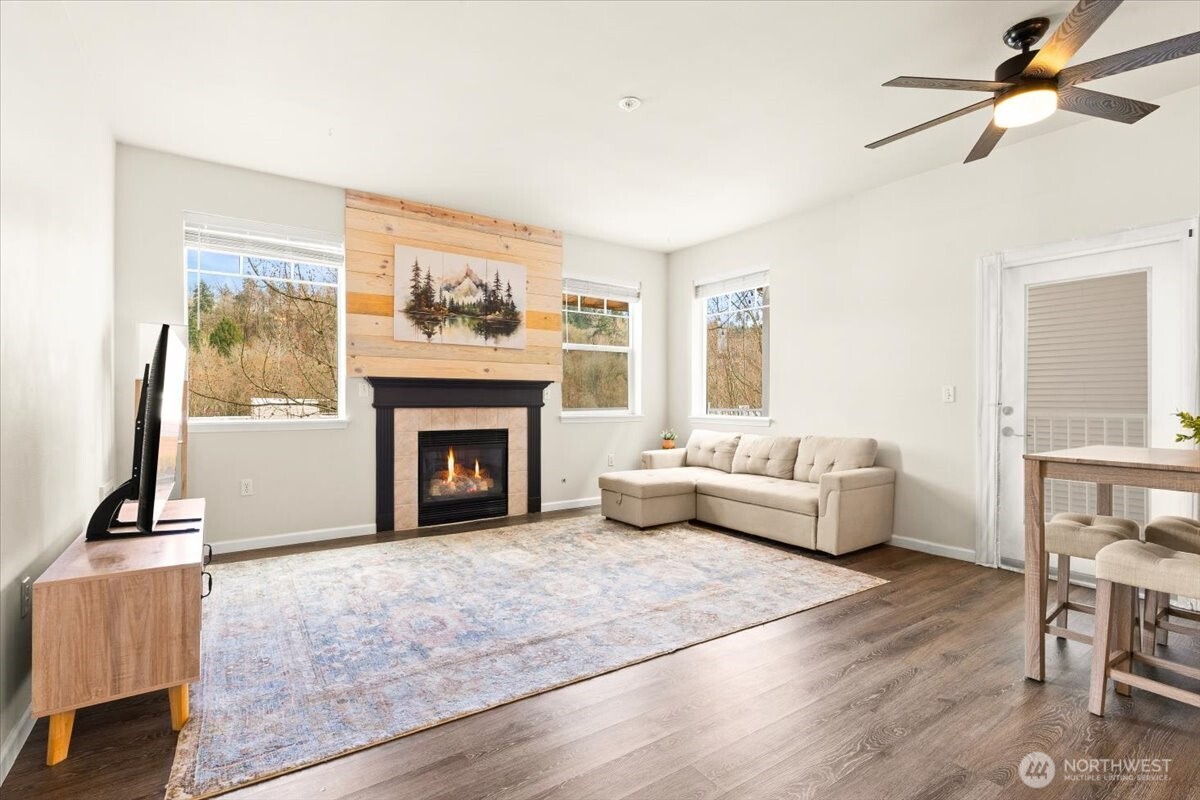 17426 Bothell Way Northeast, Unit A302 Bothell, WA 98011 - Photo 4 of 40 a living room with furniture and a fireplace