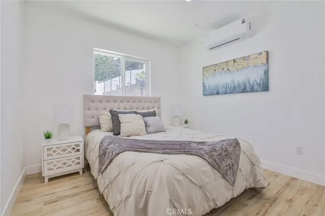 a bedroom with a bed and a wall painting