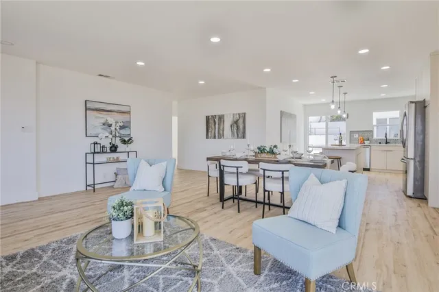 a living room with furniture and kitchen view