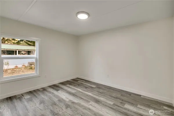 a view of room with window and wooden floor