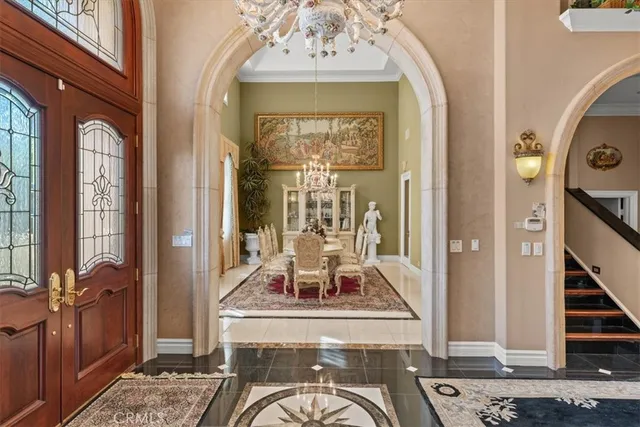 a view of a dining room with furniture and chandelier