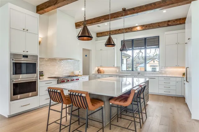 a kitchen with a table chairs stove and cabinets