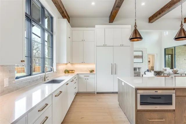 a kitchen with a sink stove and cabinets