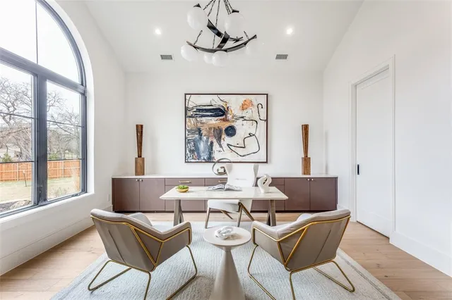 a living room with furniture a table and a large window