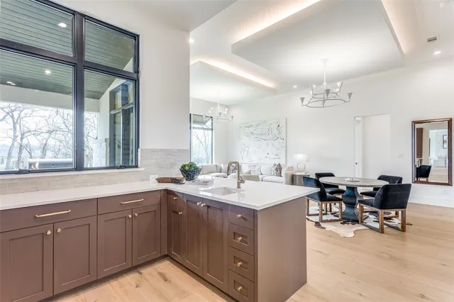 a kitchen with a sink stove and table