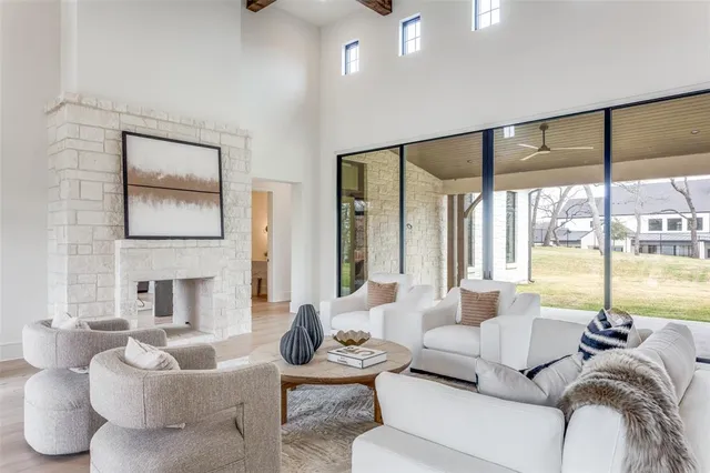 a living room with furniture and large windows