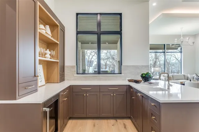 a kitchen with a sink and large window